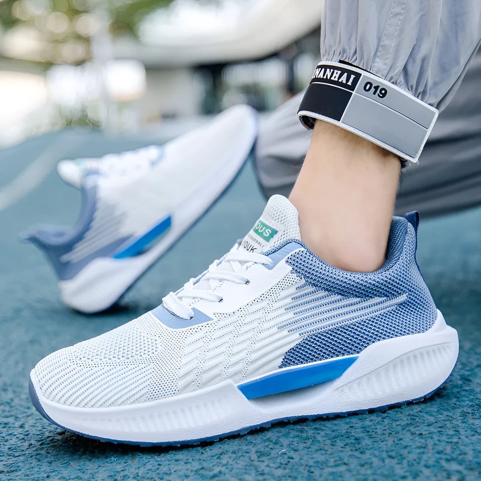 Men's blue casual mesh shoes with round toe and cloth upper on a plain background.