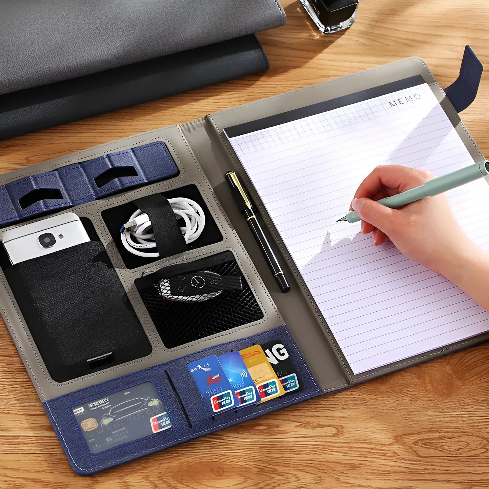 Black leather A4 folder open to show notepad and pen slot, measuring 325mm by 250mm.