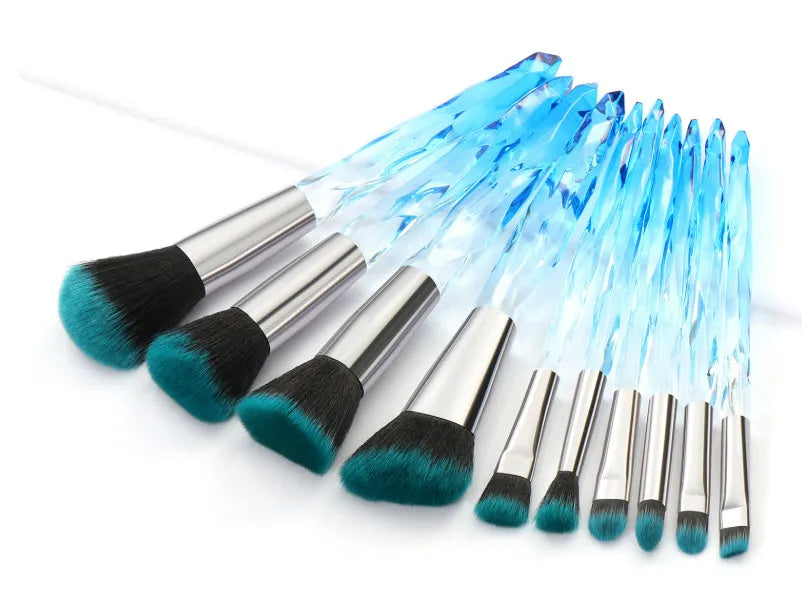 10 clear crystal handle foundation brushes with diamond shanks, showing black, blue, red, and yellow colour options.