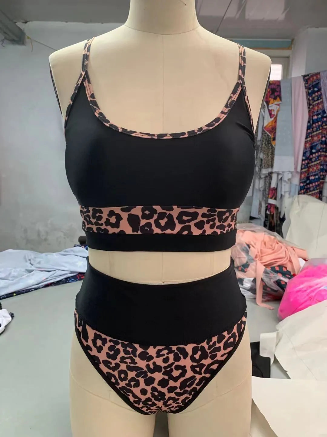 White and leopard print women's high-waist bikini swimsuit set on a mannequin.