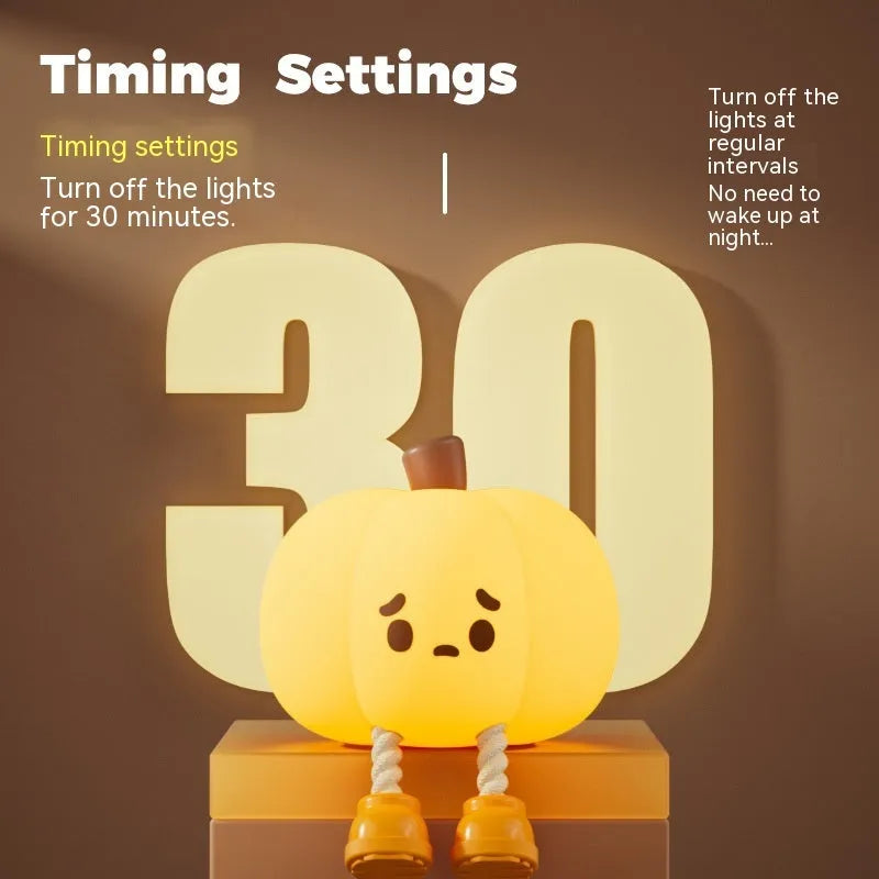 Soft orange silicone pumpkin-shaped night light with a warm glowing face on a table.