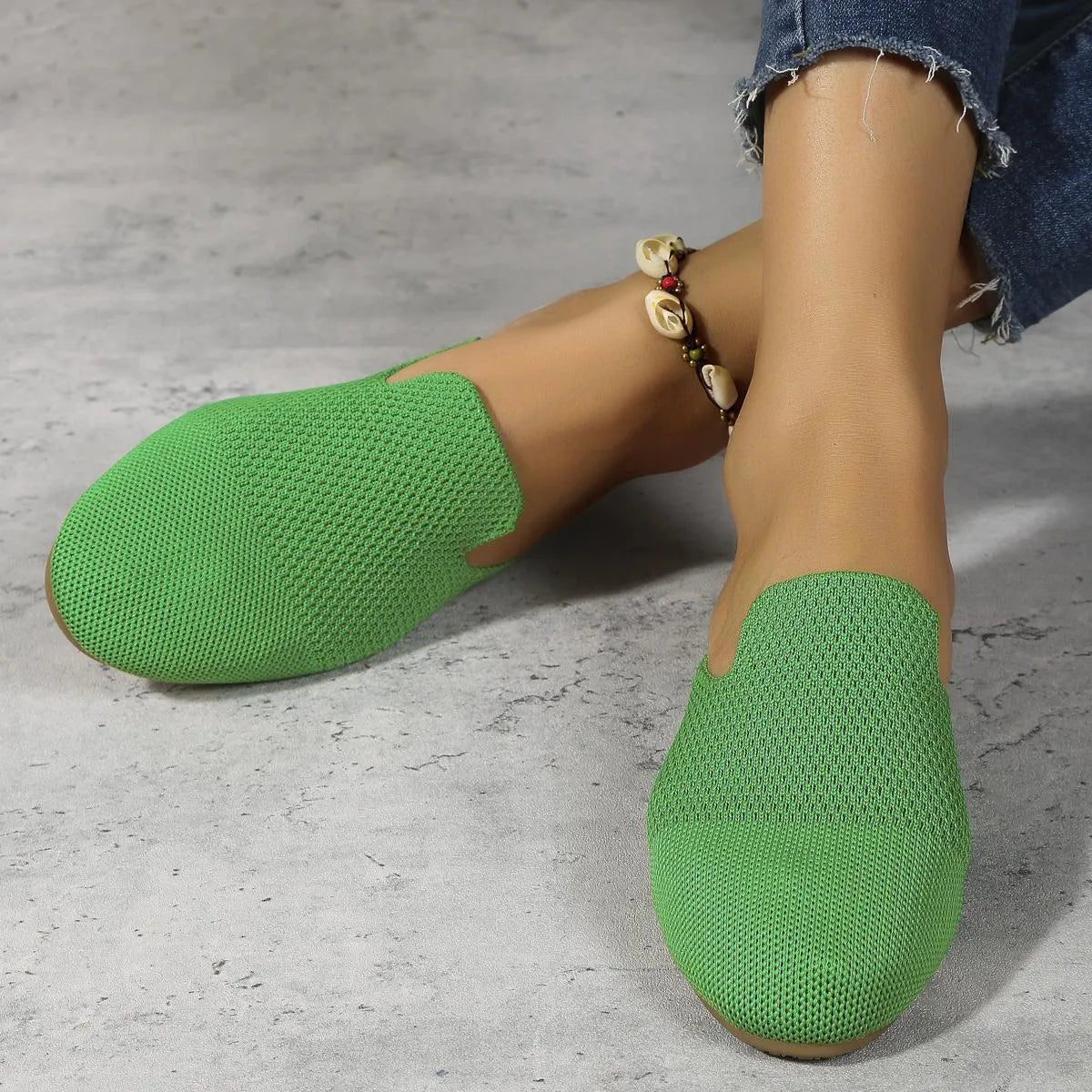 Apricot, blue, and green mesh slip-on sandals with a round toe and flat rubber sole.