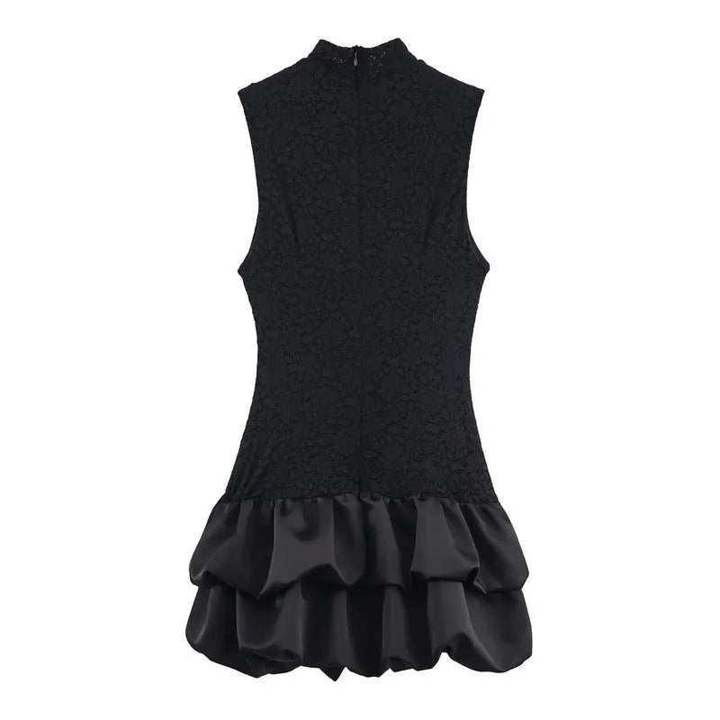 Women's black cotton short dress with lace stitching and asymmetric skirt on a plain background
