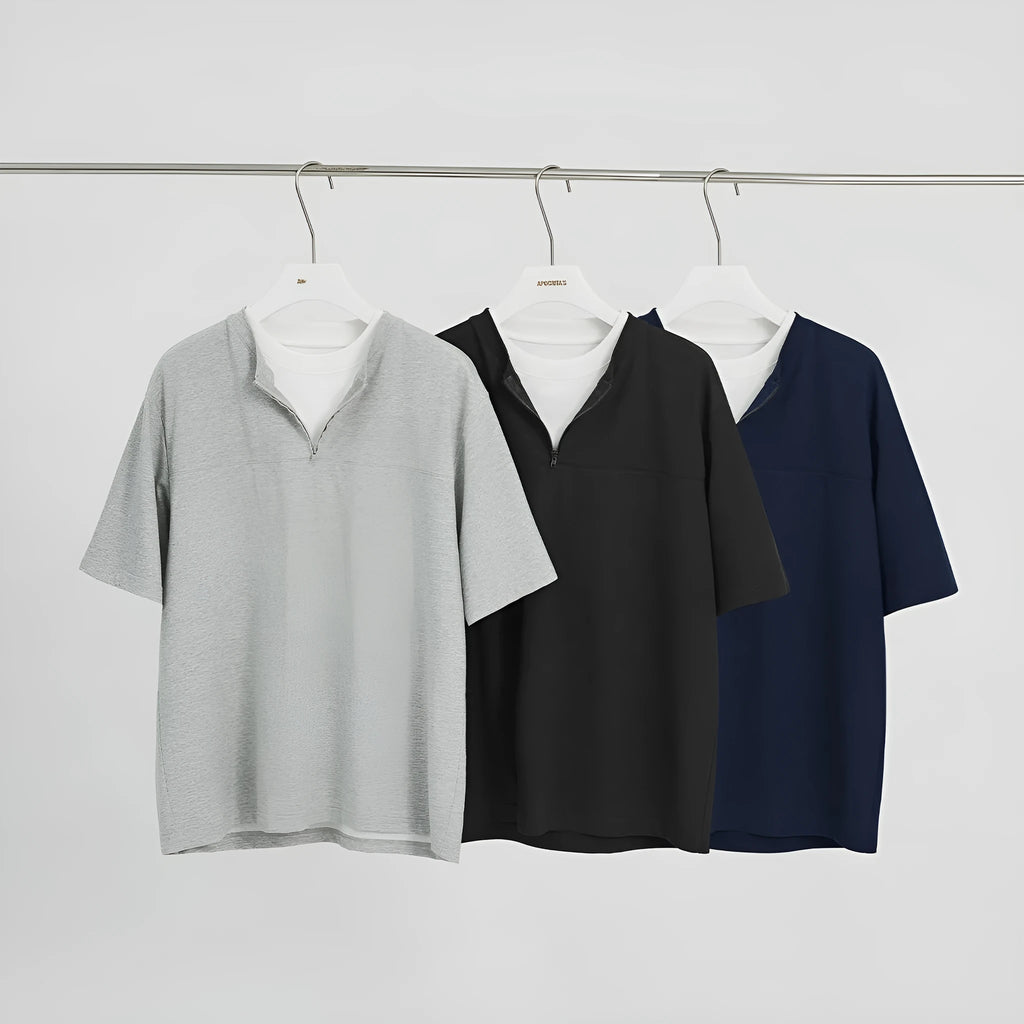 Women's loose blue patchwork top with false two-piece design on a hanger.