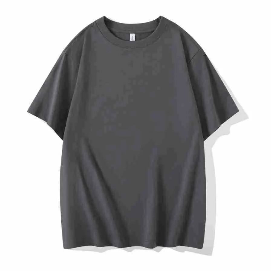 Man wearing a heavyweight dark grey drop shoulder T-shirt with layered shoulder detail.