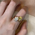 Geometric open copper ring with a water drop double sheng stone and contrasting zircon.