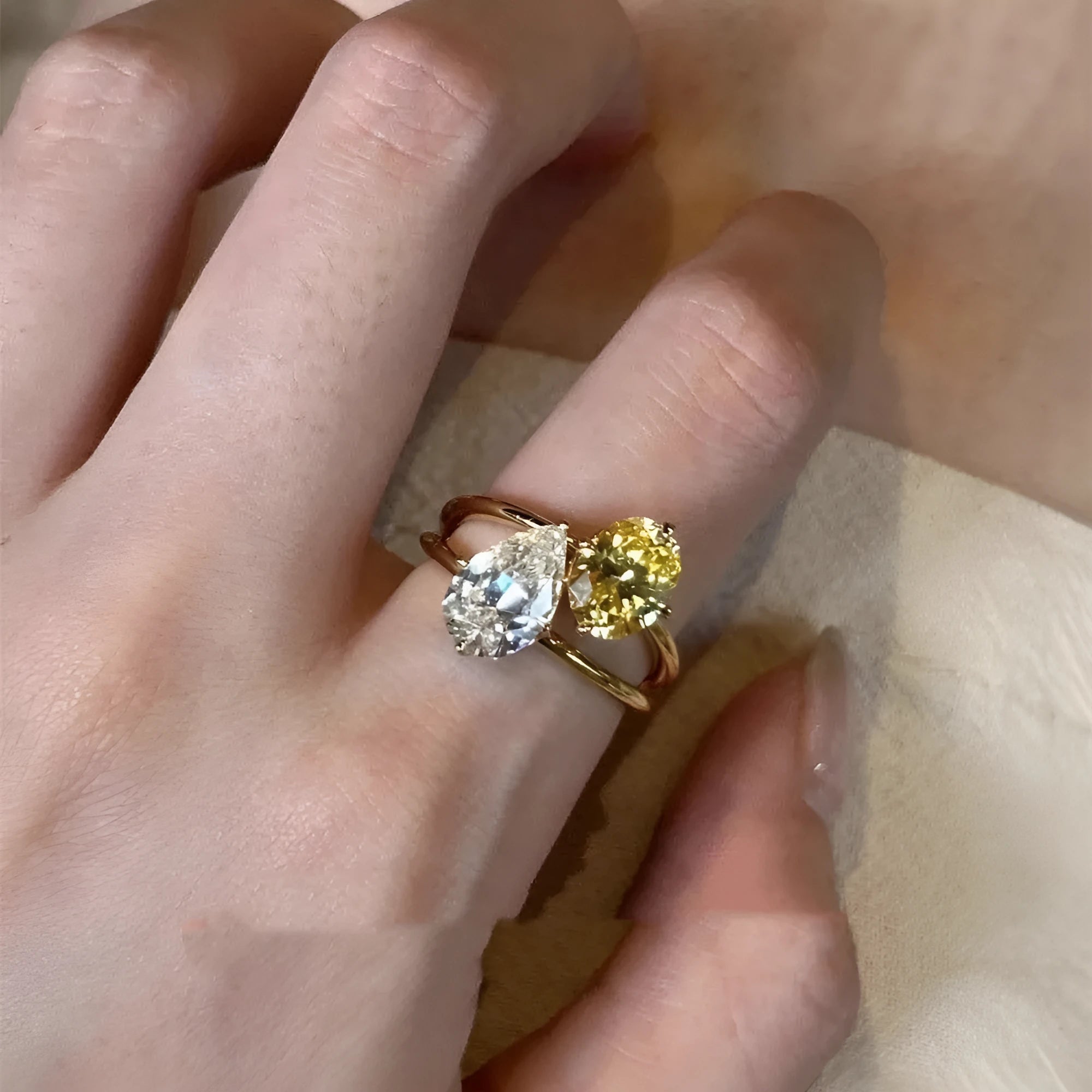 Geometric open copper ring with a water drop double sheng stone and contrasting zircon.