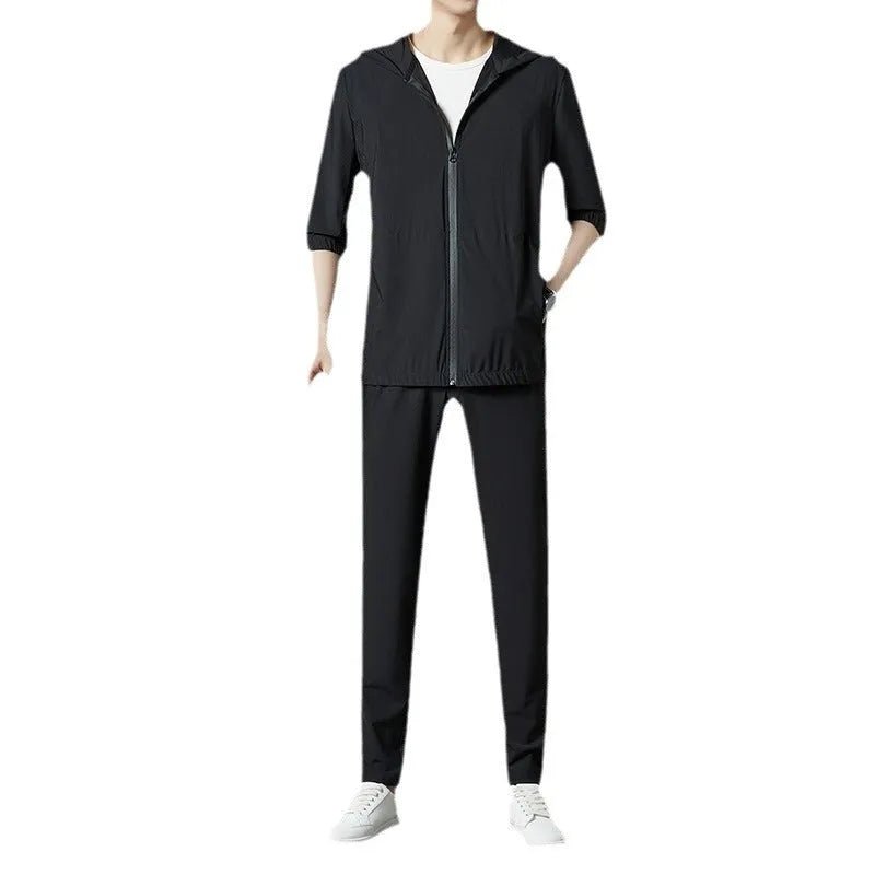Grey hooded sun-protective top and trousers casual set laid flat showing loose fit and pocket detail