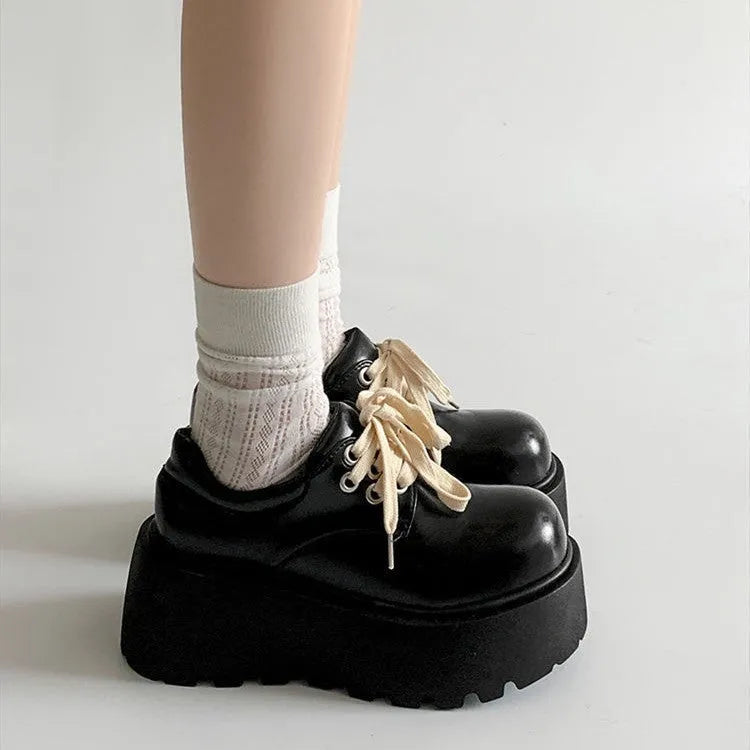 Matte black women's lace-up shoes with a high English muffin heel and thick rubber sole.