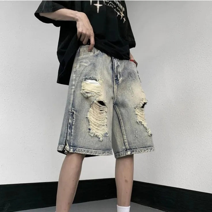 Blue retro tattered denim shorts with a wide leg loose fit on a person