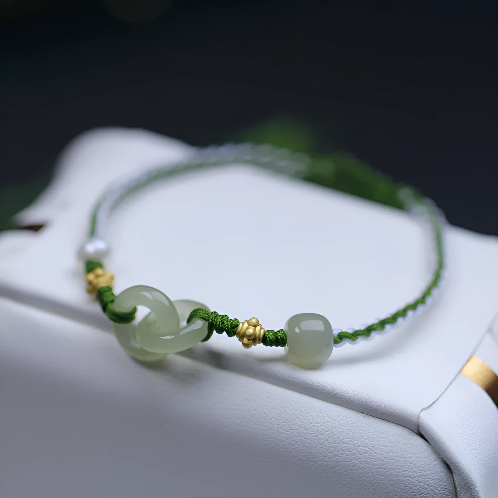 Hetian jade woven bracelet with flexible wire and hollow-out metallic elements