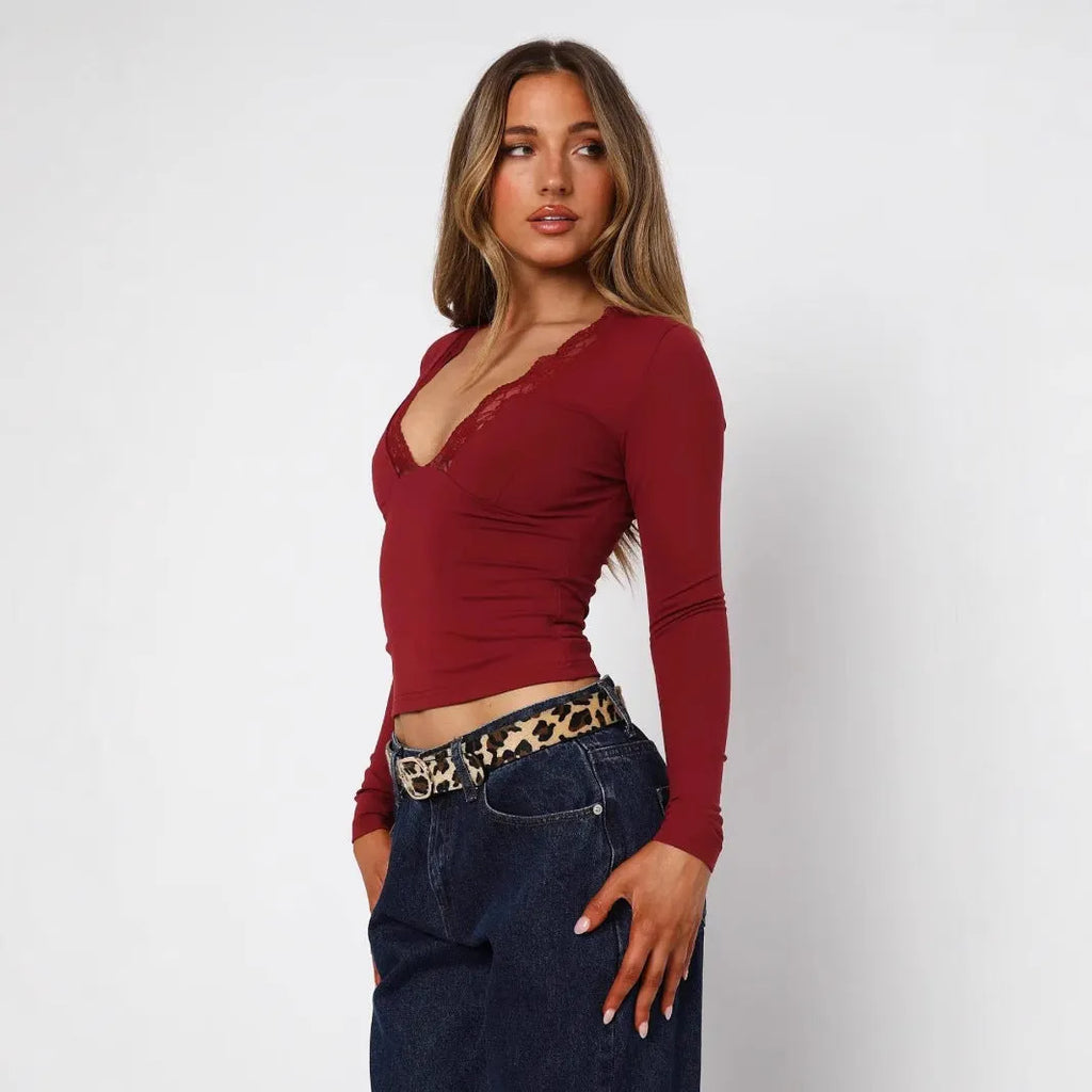 Black slim-fit women's long sleeve top with floral lace detailing on the front.