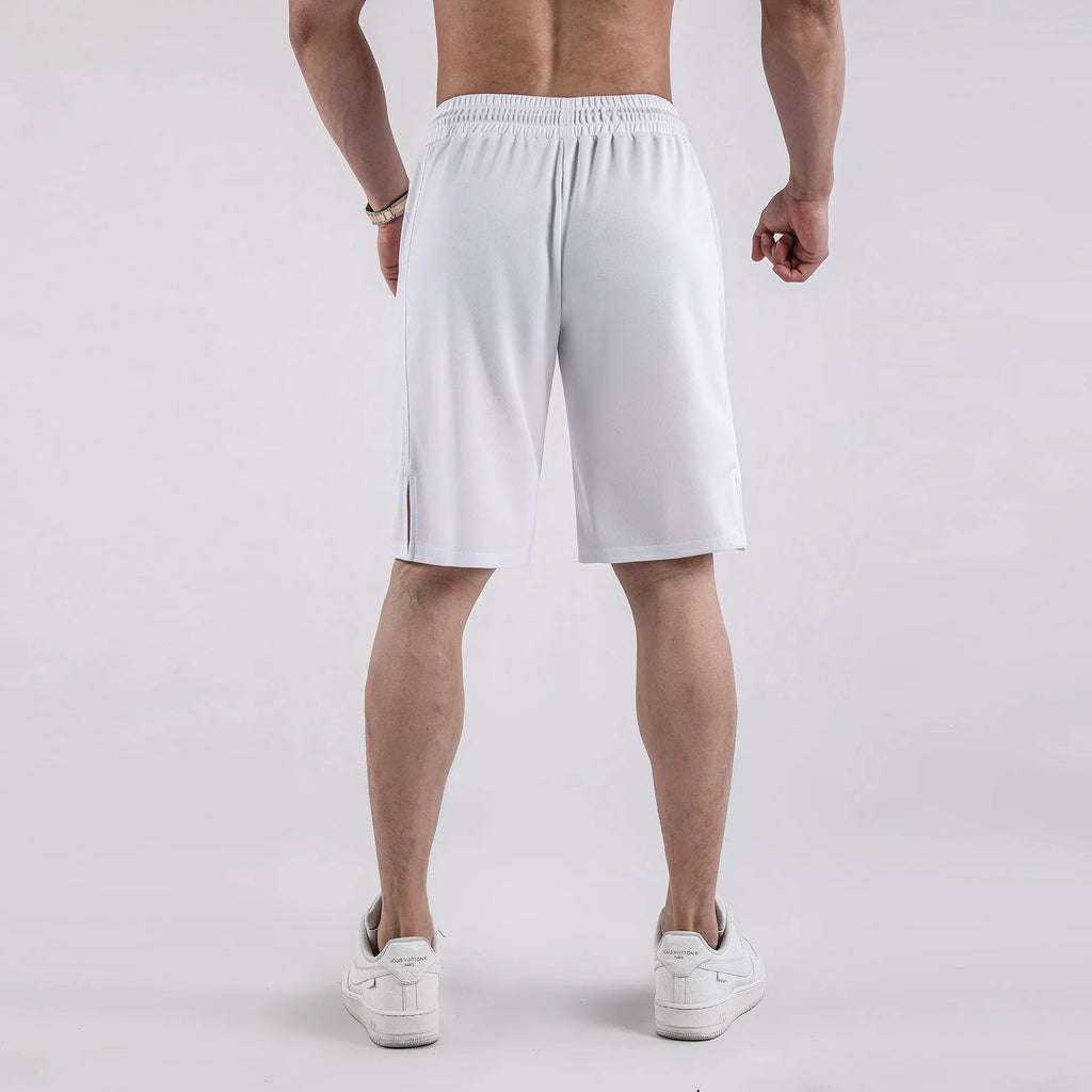 Man wearing black quick-drying mesh fitness shorts with an elastic mid-waist and loose fit.