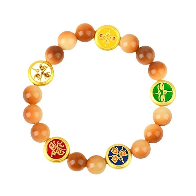 Yellow Bodhi seed bracelet with five directions geometry pattern on wooden surface