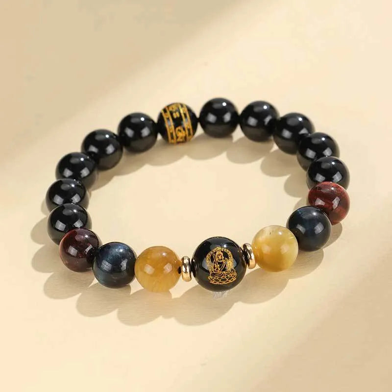 Handmade black agate beaded bracelet with gold, blue, and red tiger eye stones featuring Buddhist deity and zodiac animal motifs.