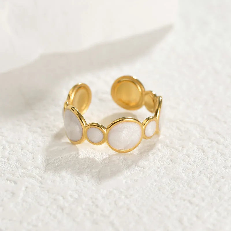 Adjustable stainless steel ring with a geometric shape and electroplated metallic finish.