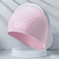 Silicone water drop swimming cap for adults in various solid colours on white background