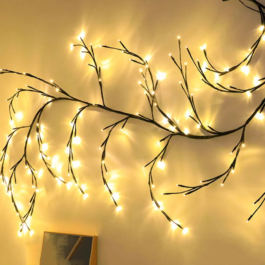 Flexible willow vine Christmas garland with birch bark texture and warm white LED lights extended along wall