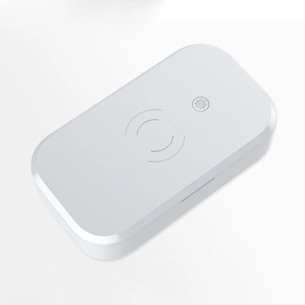 White ultraviolet disinfection box with wireless charging pad on top for mobile phones.