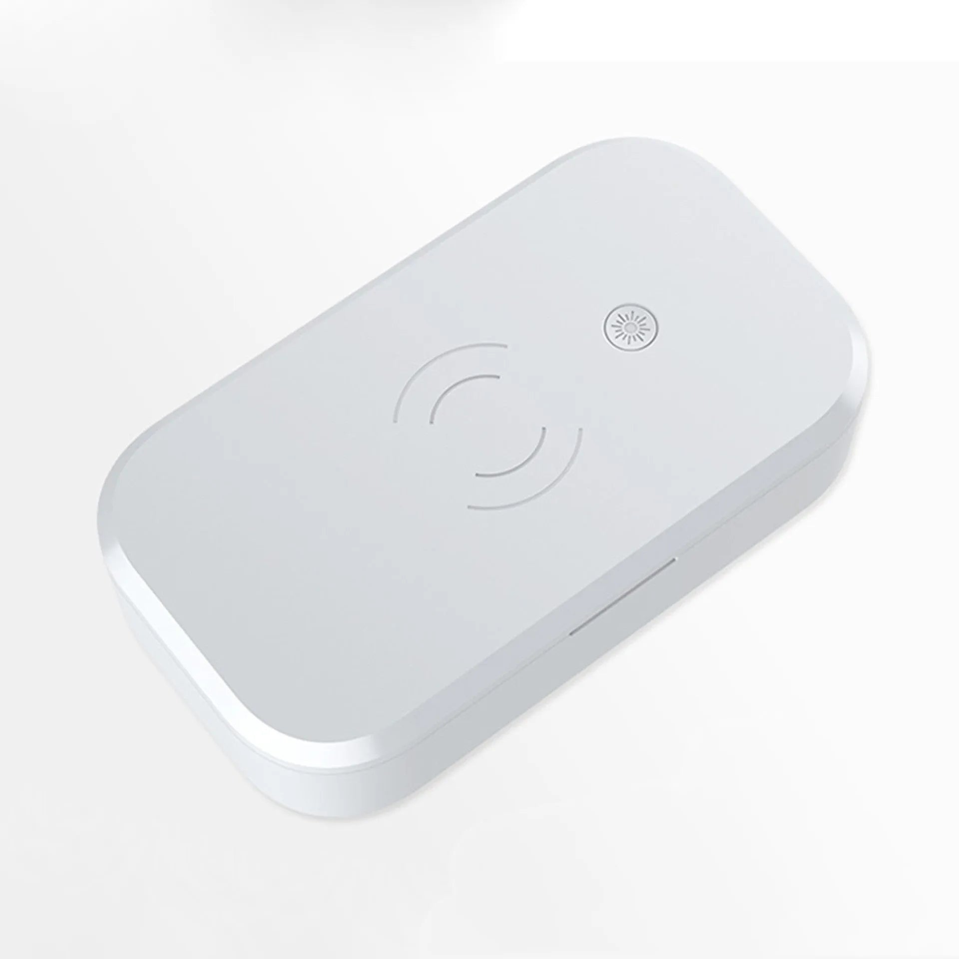 White ultraviolet disinfection box with wireless charging pad on top for mobile phones.
