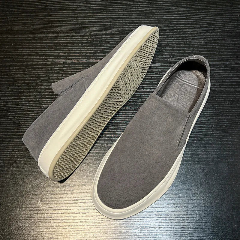 Men's grey casual shoes with round toe design and sewing line detailing showing rubber soles