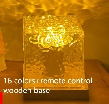 LED water ripple night light with rotating crystal projection and remote control on wooden surface