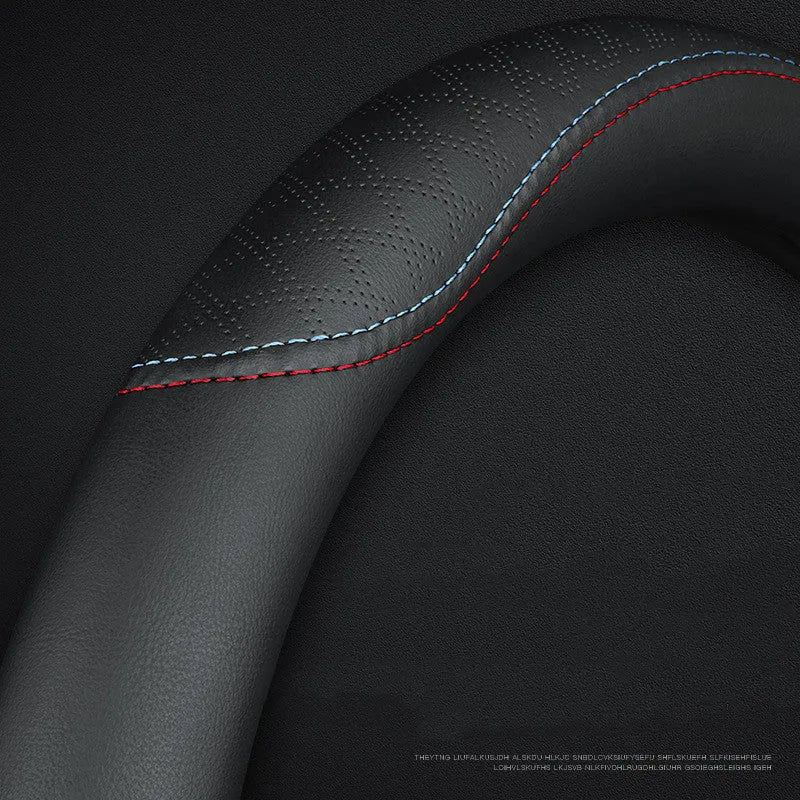 Black leather steering wheel cover with coloured stitching, shown fitted on a car wheel.