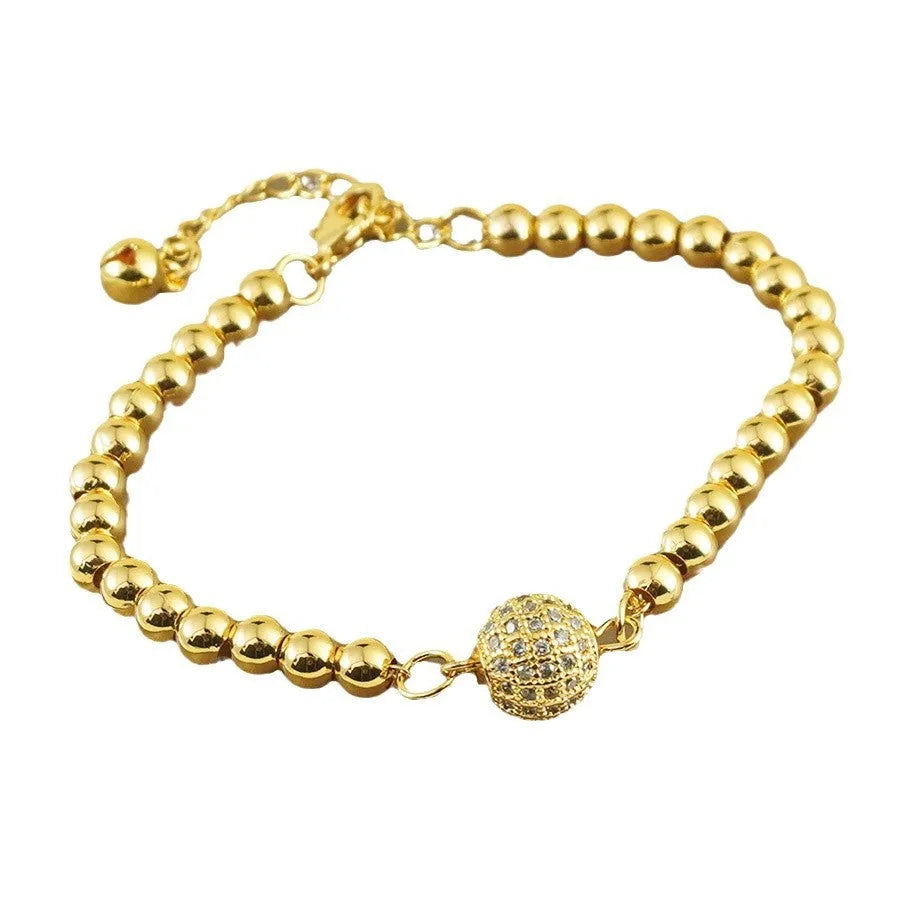 Close-up of a women's copper bracelet with a heart shape and a single round zircon stone in an Arabic-style design.