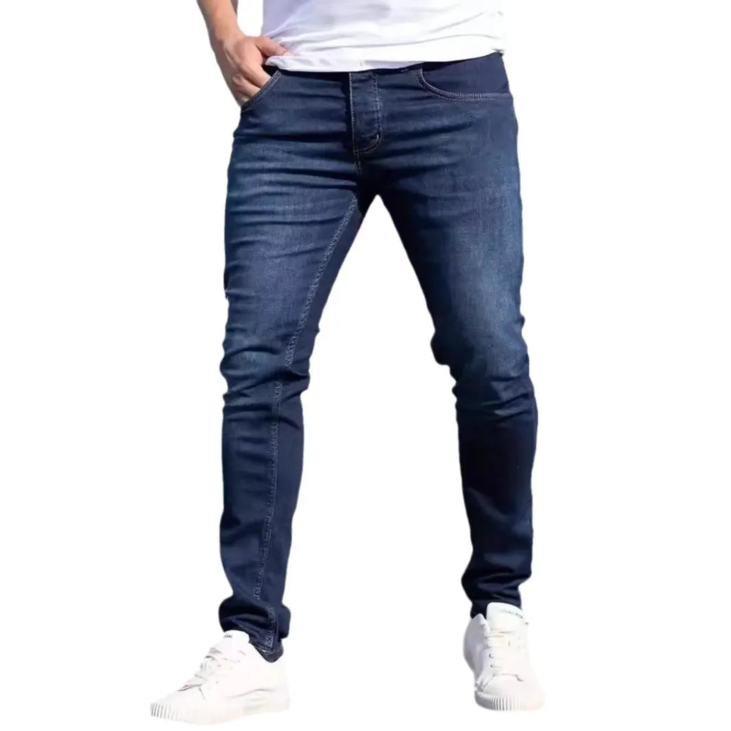 Men's dark blue skinny-fit casual jeans with a zip fly on a mid-waist.