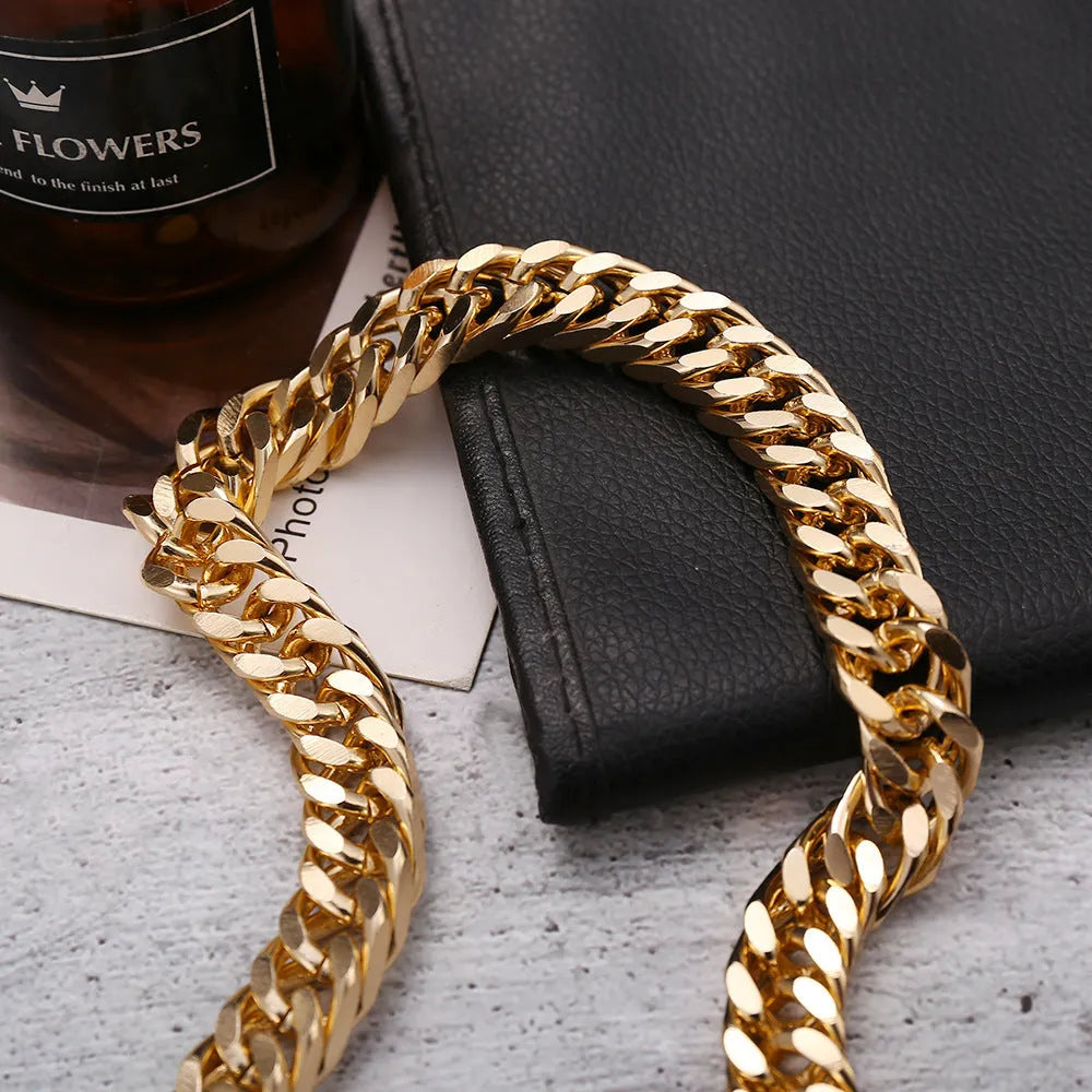 Women's gold tone thick chain necklace with a pendant on a white background.