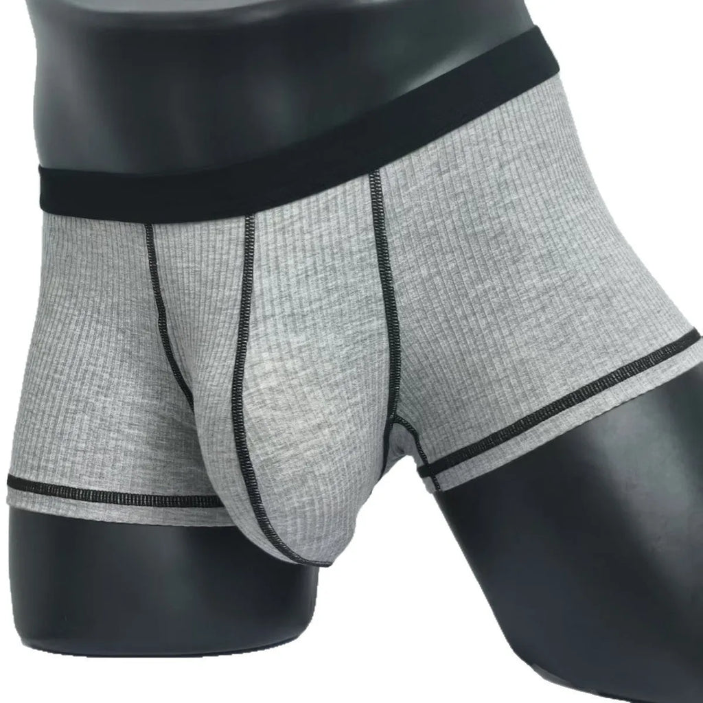 Men's solid colour boxer shorts in thin fabric, shown in army green, highlighting breathable and body-shaping design.