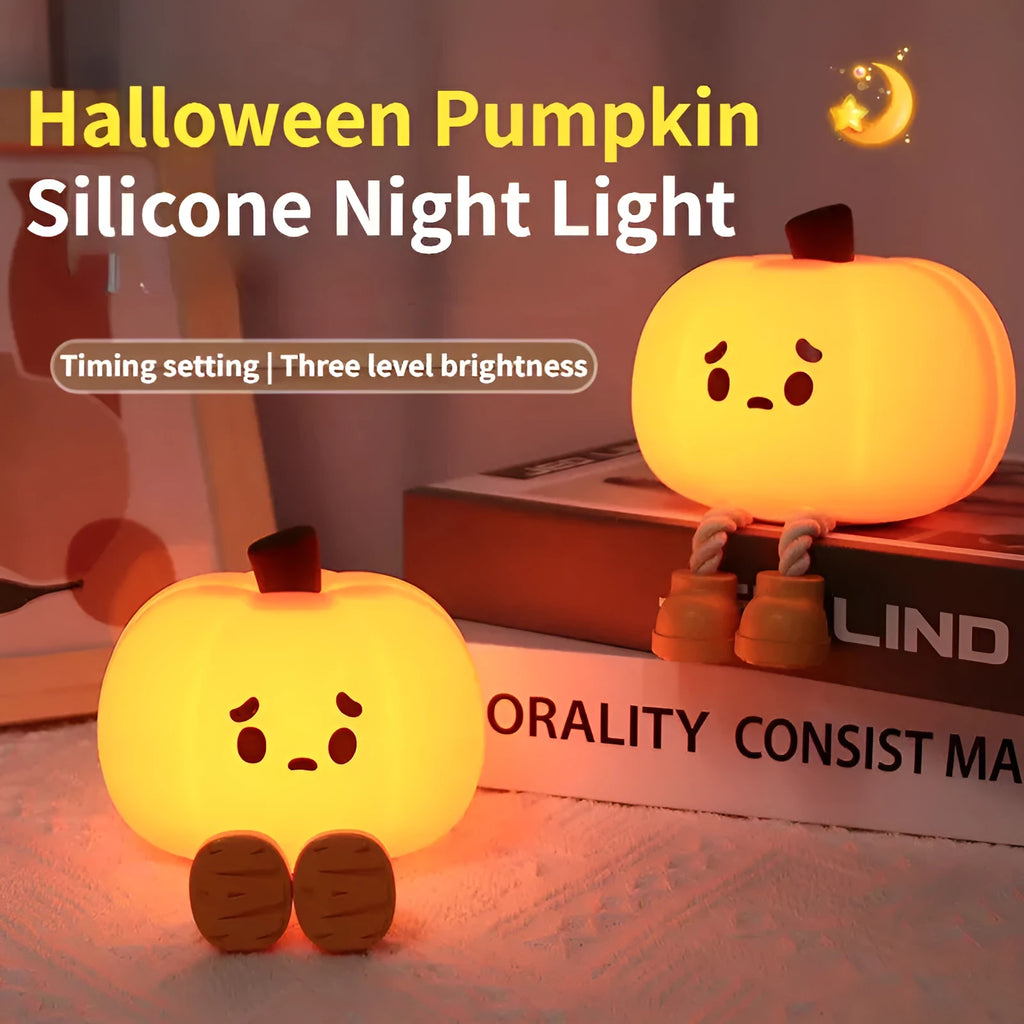 Soft orange silicone pumpkin-shaped night light with a warm glowing face on a table.