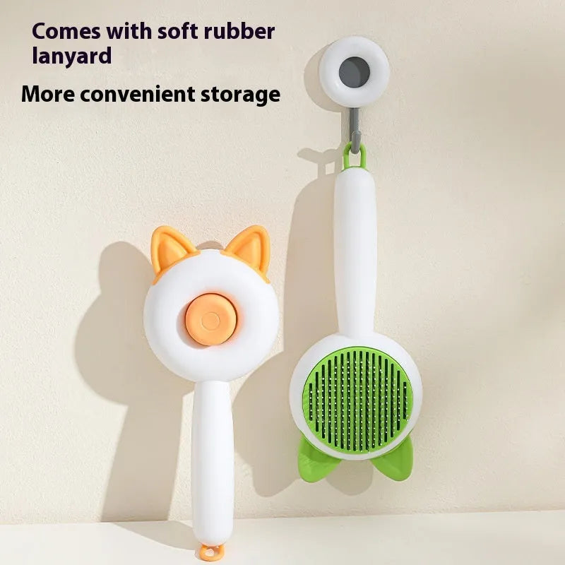 Greenish white cat grooming brush with stainless steel teeth and a self-cleaning button on the handle.
