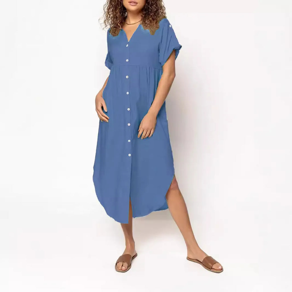 A woman wearing a loose-fitting, solid-colour midi dress with a button-down front and regular sleeves.