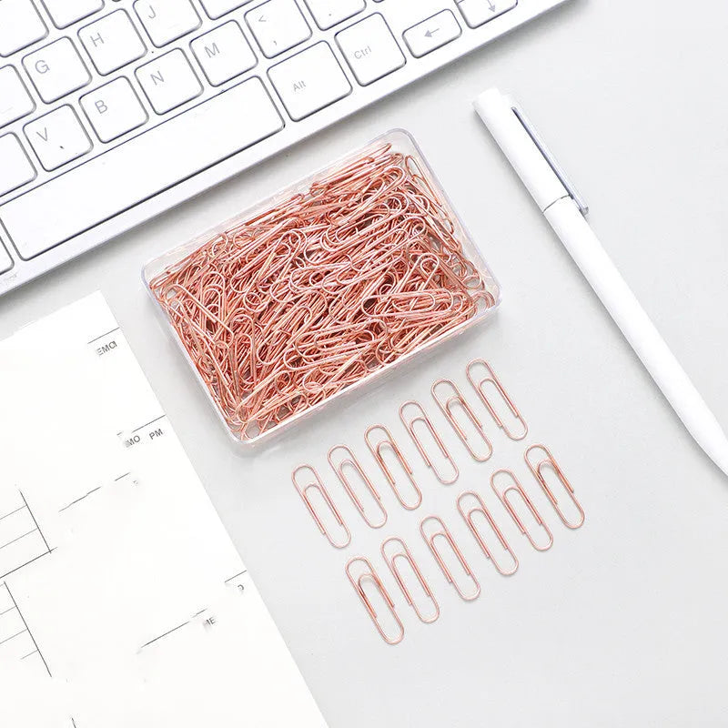 Rose gold heart-shaped metal paper clips measuring 28mm with steel core construction