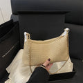 Khaki straw woven horizontal square tote bag with shoulder straps and outer sandwich pocket.