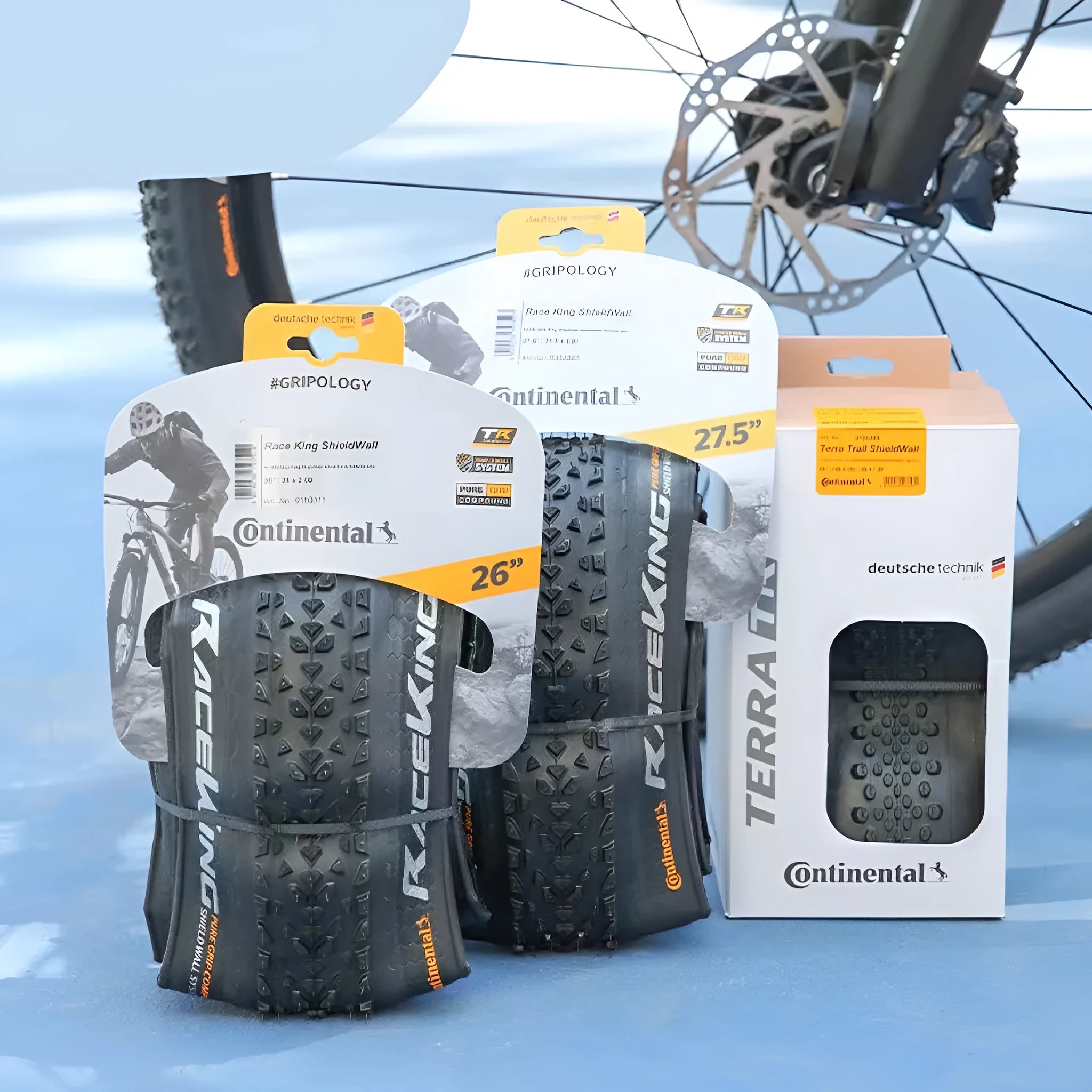 Mountain bike folding tyre with 3-layer construction shown in yellow or white sidewall options