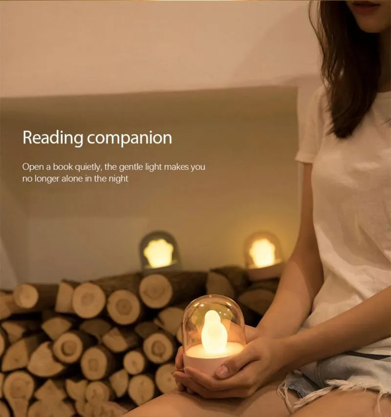 Grey cat paw shaped USB rechargeable night light with musical features on wooden desk