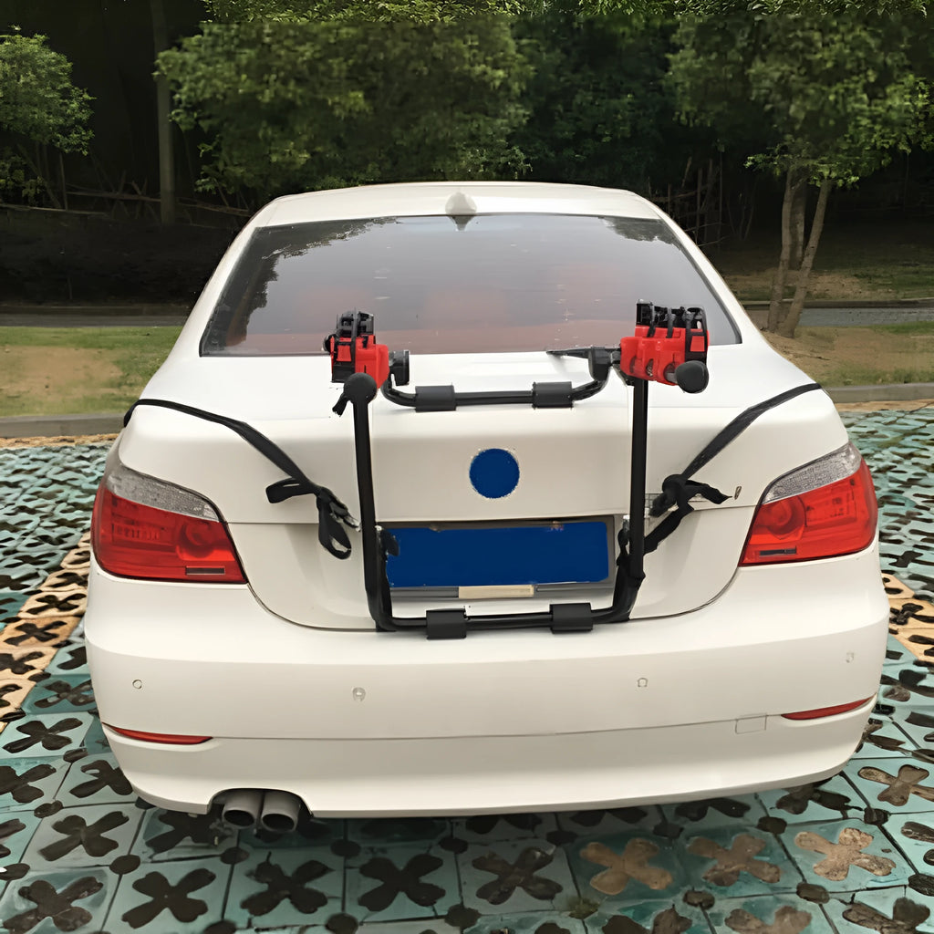 Black and red iron car boot bike rack with sponge padding and securing straps.