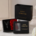 Red Korean-style jewellery gift box open to show six pink soap flowers, with a black handbag beside it.