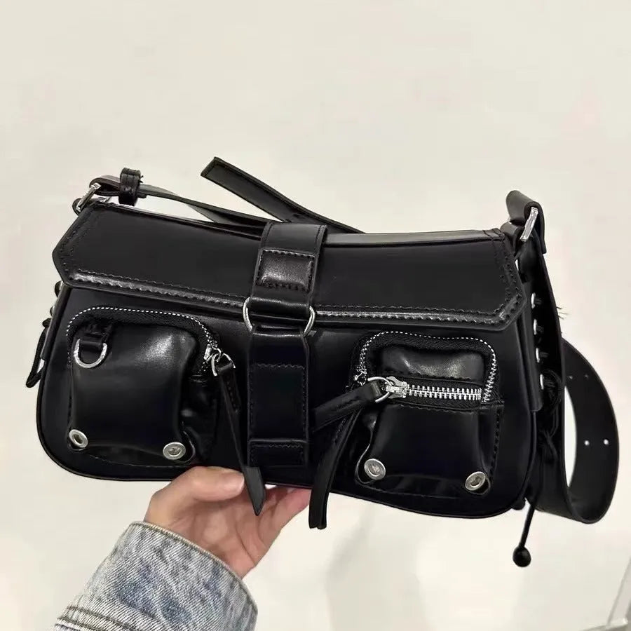 Black women's underarm baguette bag with adjustable shoulder strap showing internal zippered change compartment