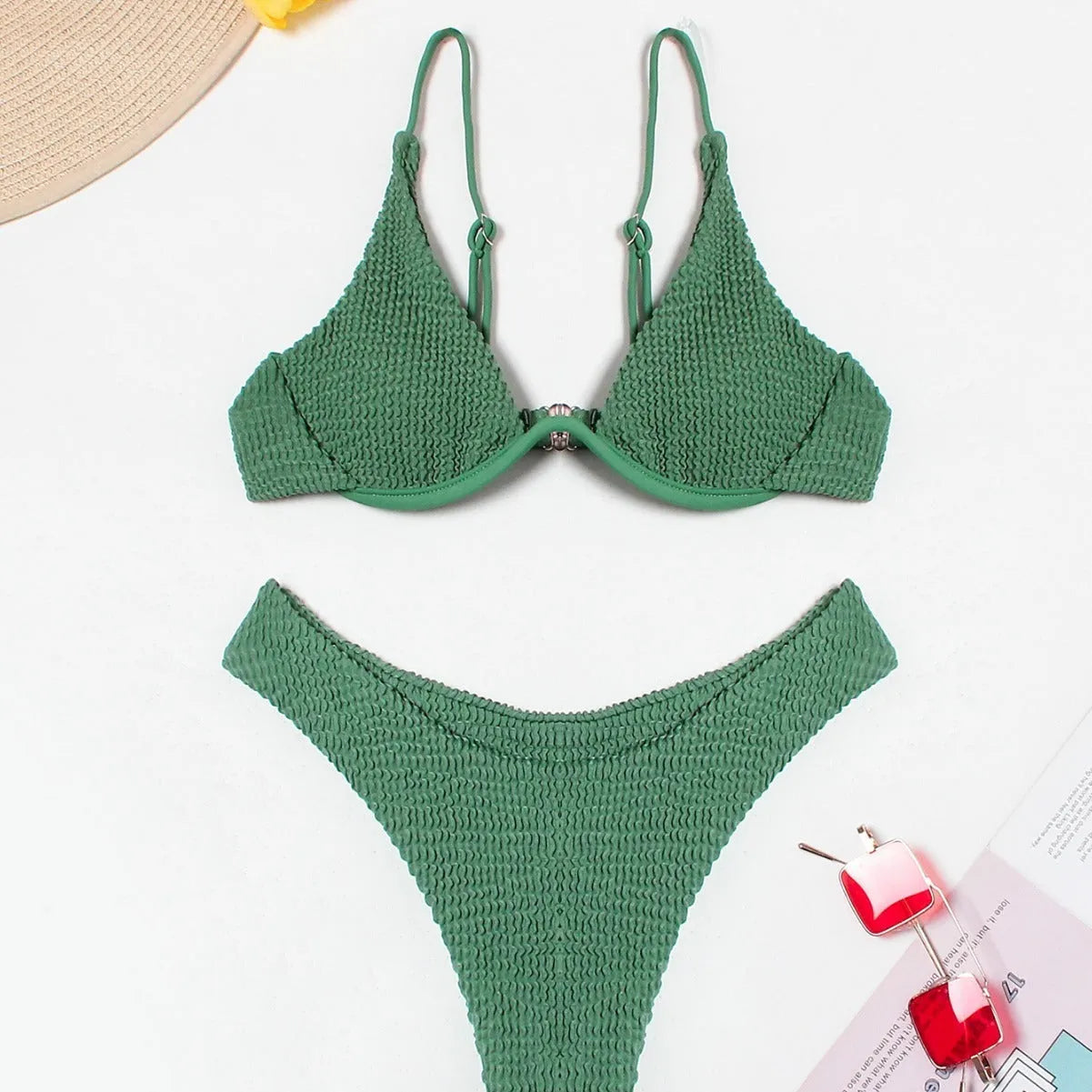Green women's bikini set with ruffle trim, showing top and split briefs made from quick-dry polyester fabric.