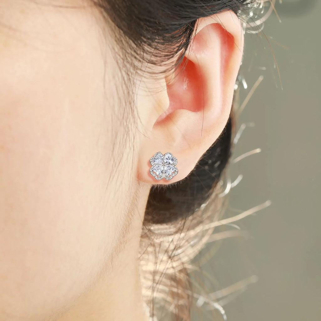 Pair of silver heart-shaped earrings with a four-leaf clover design and zircon stones in white gold colour.