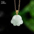 Emerald light green jade cat's paw pendant with 18K gold buckle and certificate on a white background