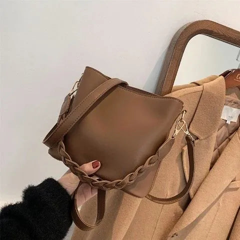 Retro style woven PU one-shoulder crossbody bucket bag in khaki colour.