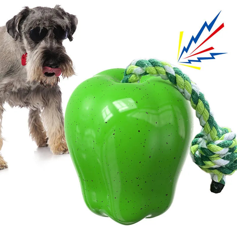 Green and red plastic apple-shaped dog chew toy with squeaker.