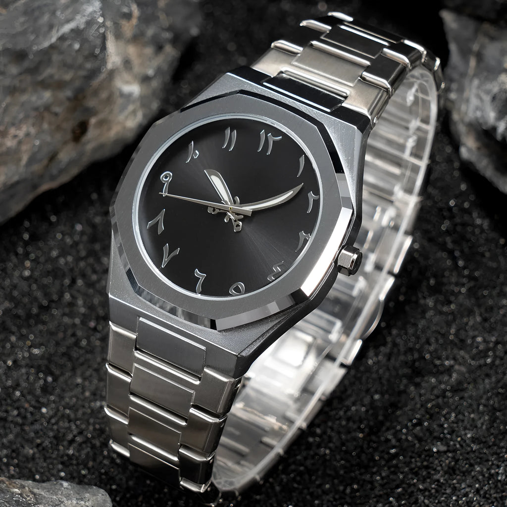 Men's silver and black business casual watch with steel bracelet and analogue dial on a wrist.