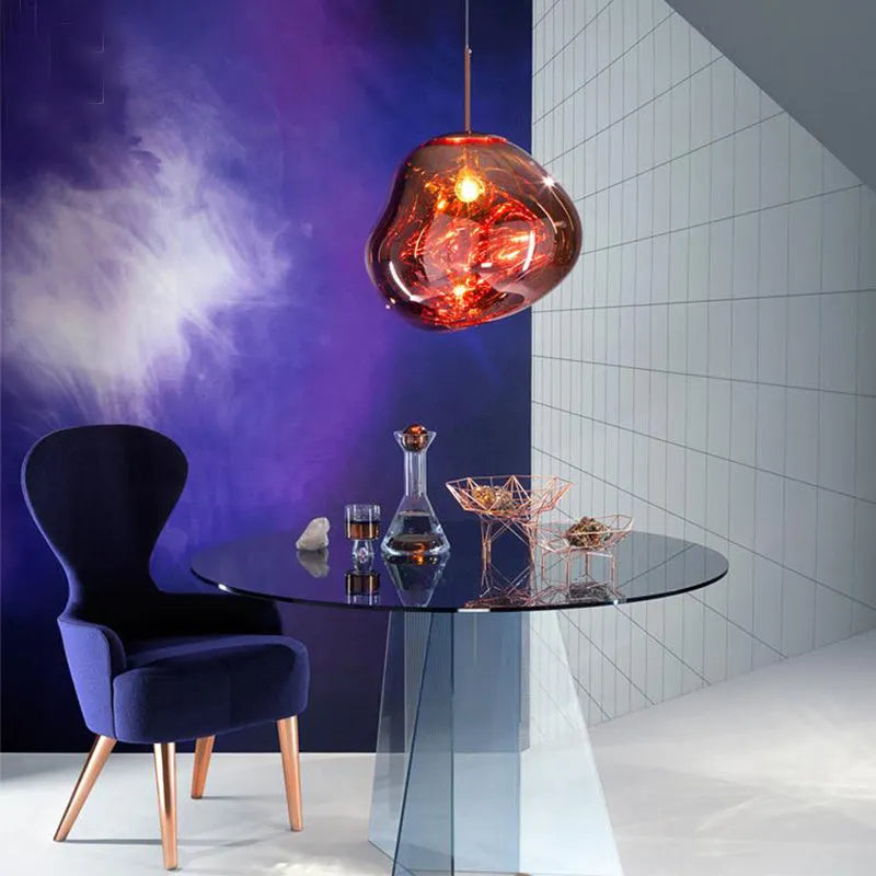 Nordic post-modern chandelier with irregular lava lamp glass design in gold finish.