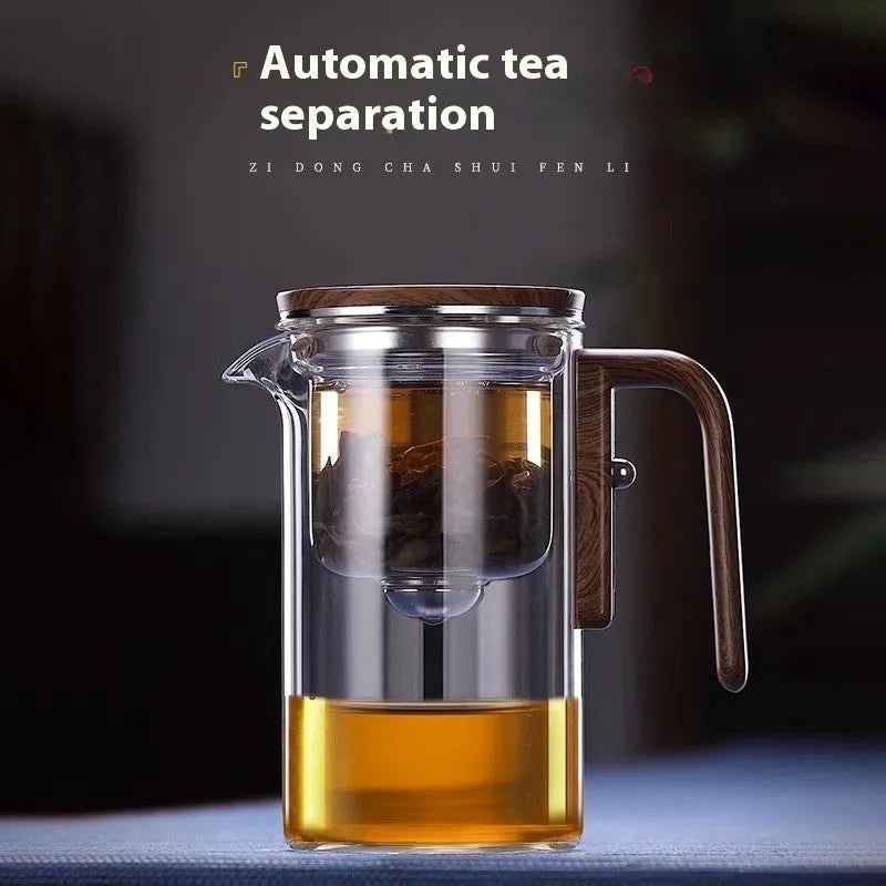 Chinese-style glass teapot with wooden handle showing magnetic filtration button and inner infuser container.
