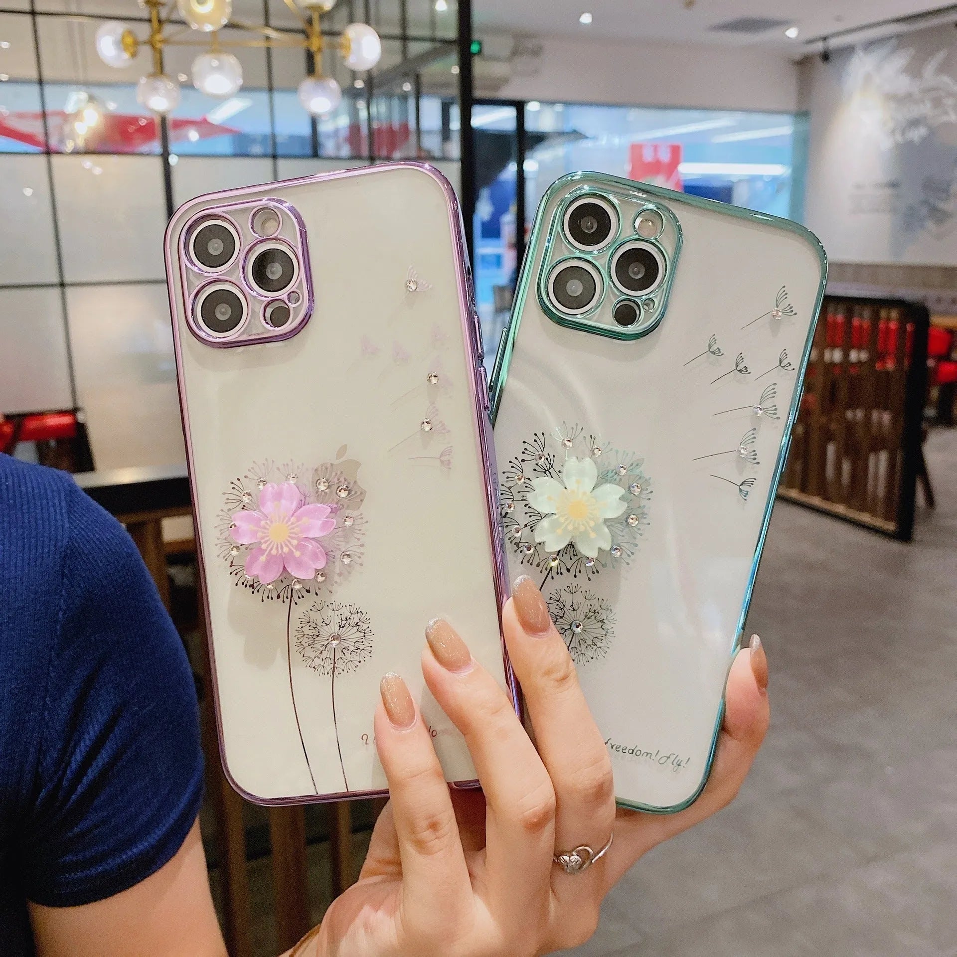 Green iPhone case with a 3D white flower design and a rotating stand on the back.
